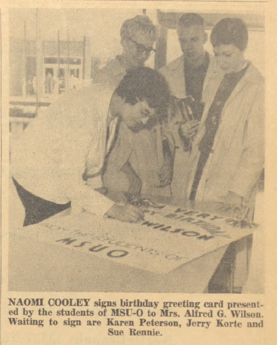 Students sign Mrs. Wilson's birthday card (photo from Oakland Observer)